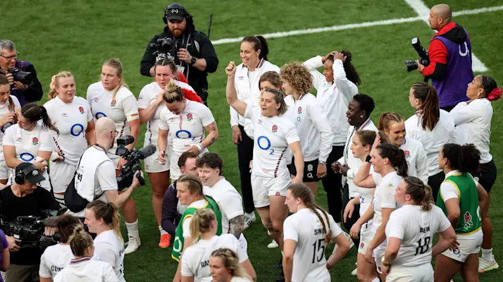 England's Claudia MacDonald celebrates among her teammates after the 2025 Grand Slam-winning match against France.