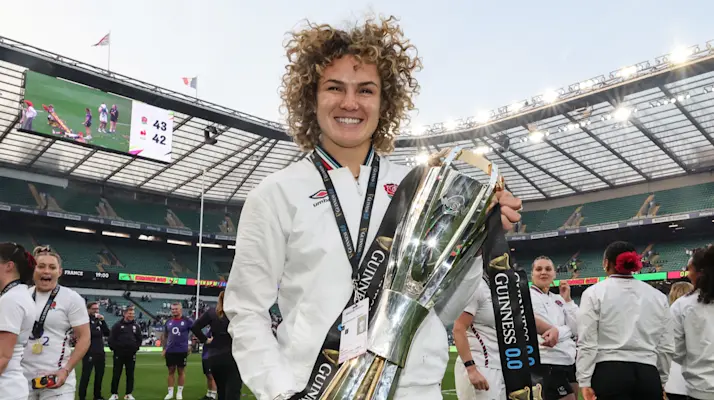 Ellie Kildunne with the Guinness Women's Six Nations trophy after completing the Grand Slam in 2025.