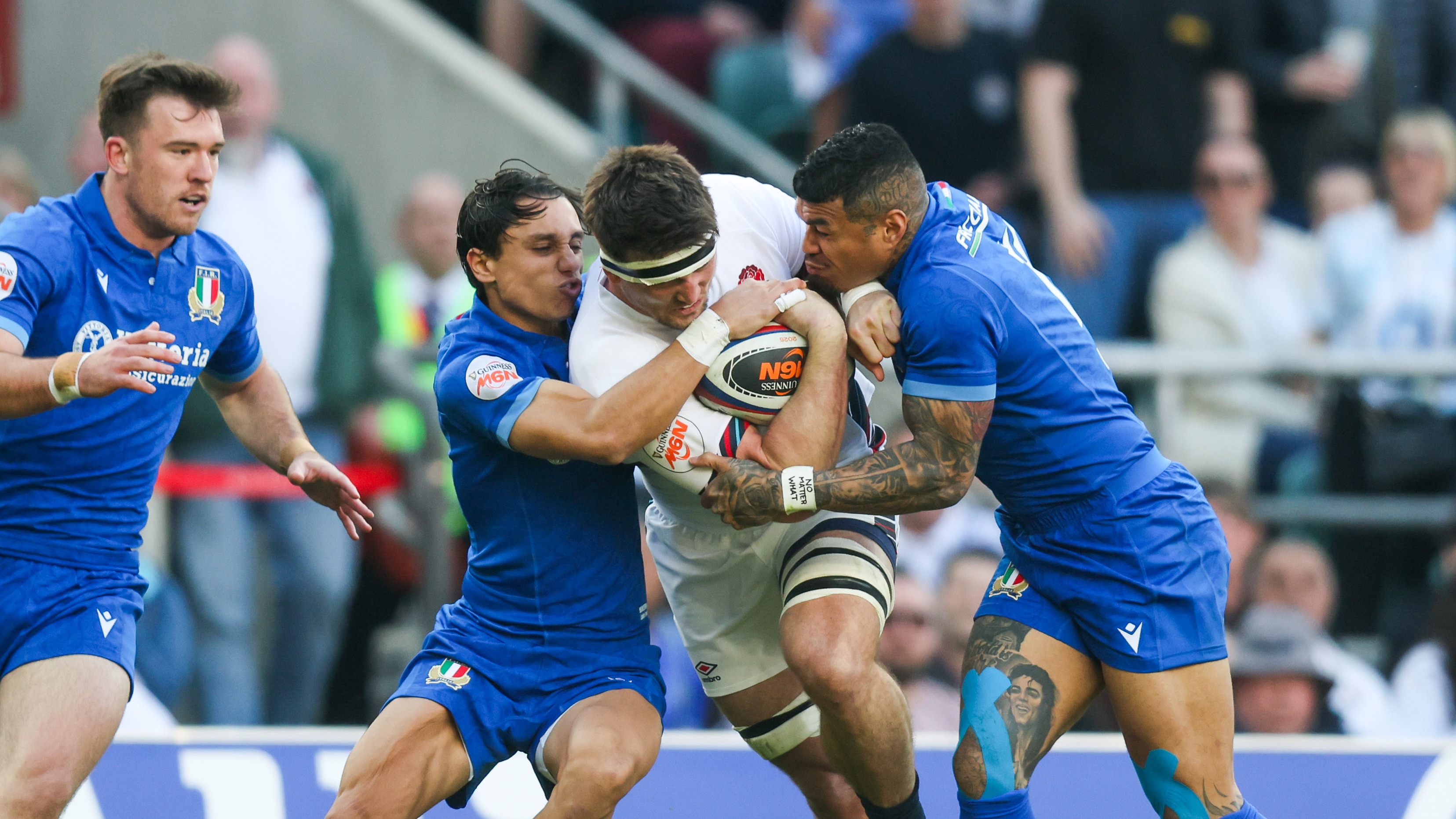 Italy's Ange Capuozzo and Monty Ioane tackle England's Tom Curry during the 2024 Championship.