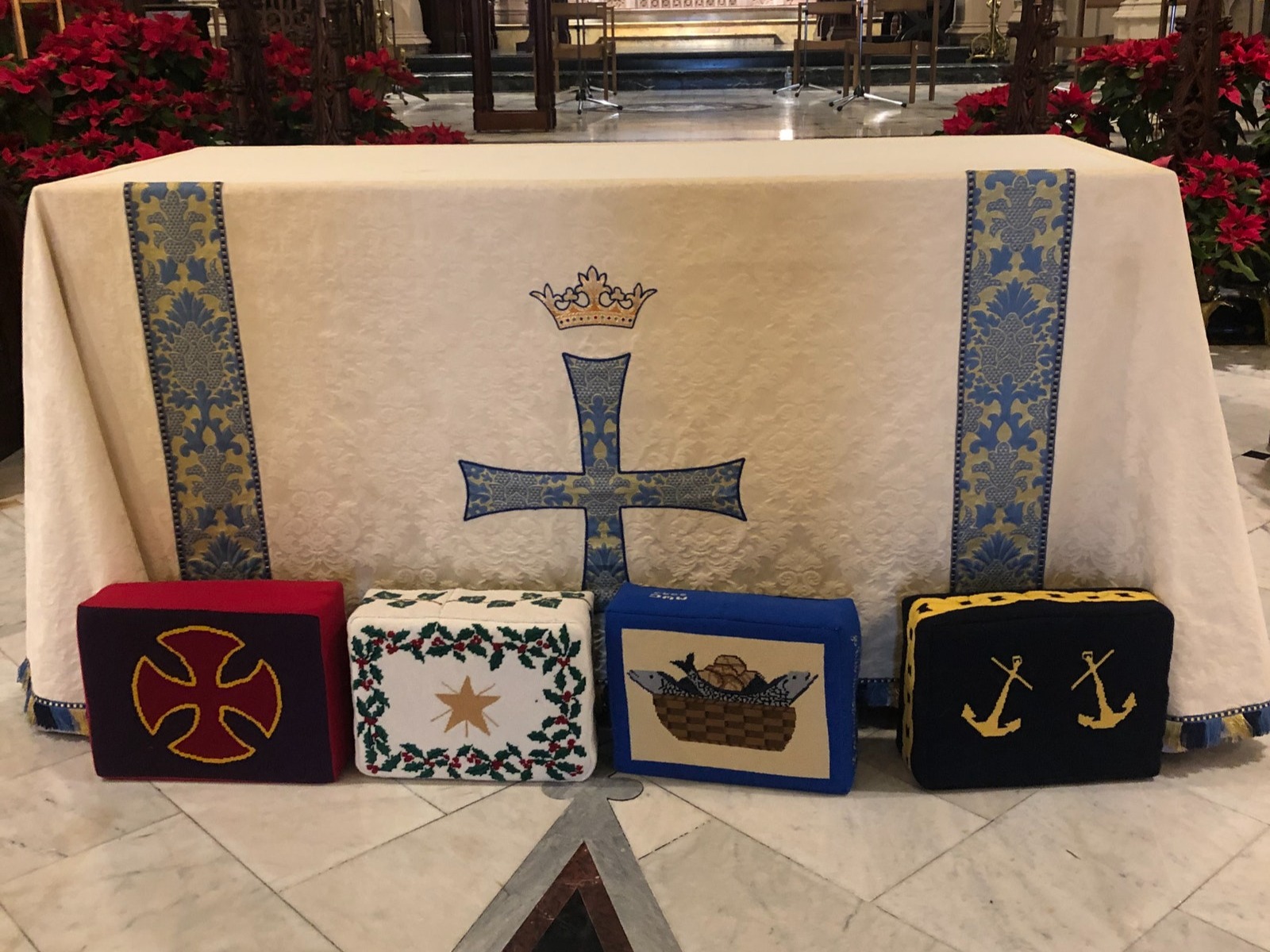 An image of four homemade needlepoint kneelers. 