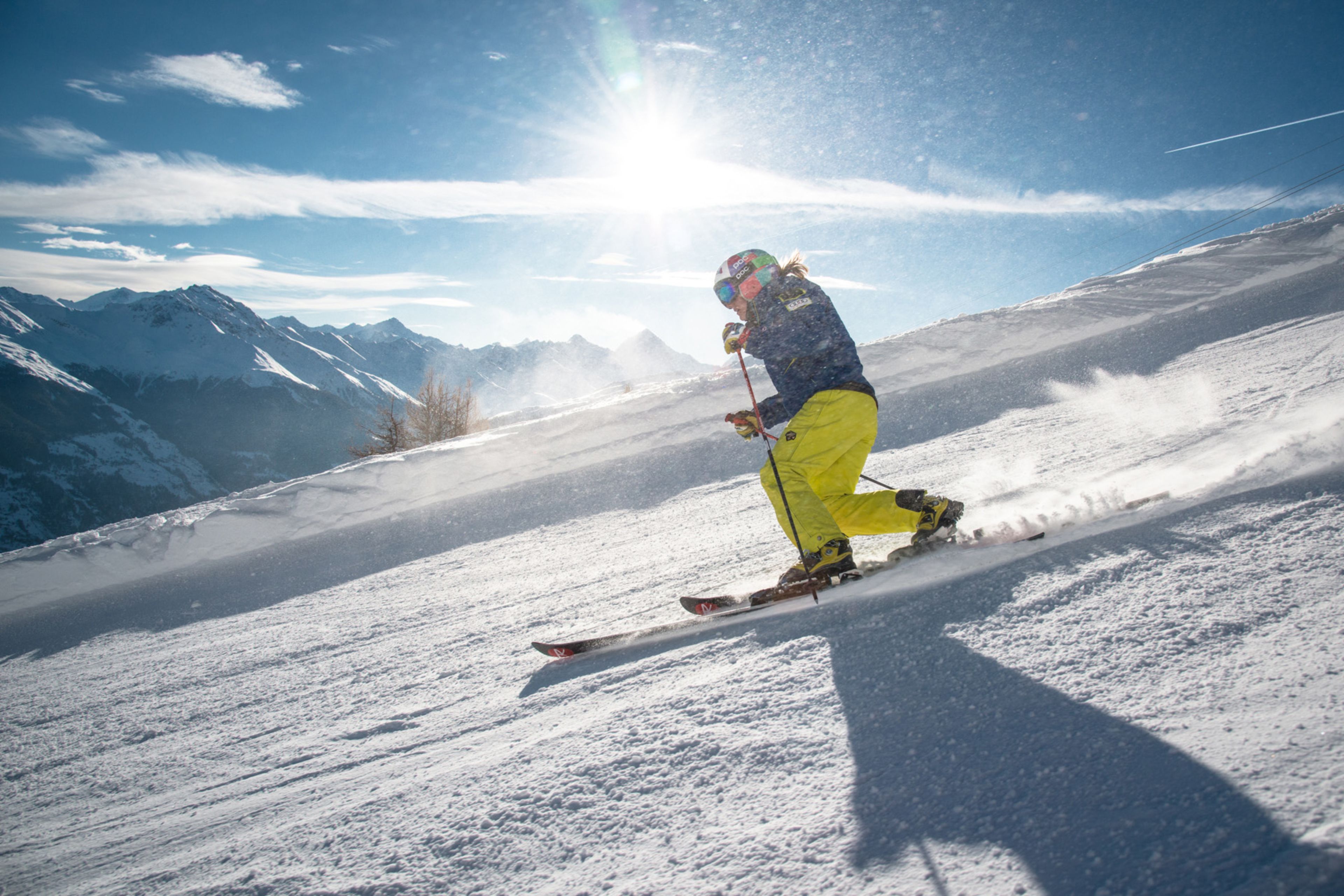 With style and grace, Amélie Reymond glides down the Ethérolla piste in Thyon. Skiing in Valais. Switzerland.