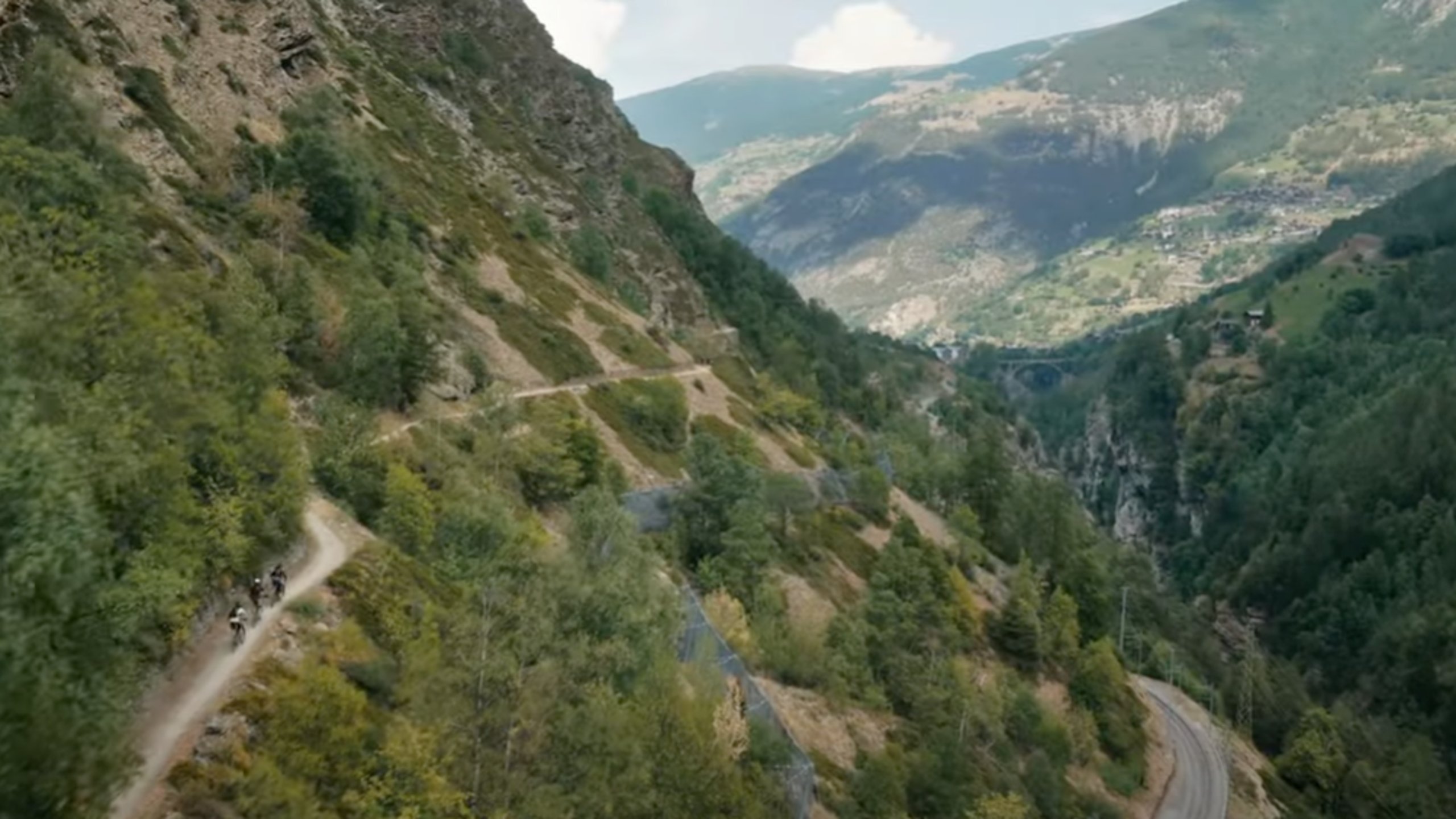 Three mountain bikers on the Valais Alpine Bike route between Graechen and Brig, Valais, Switzerland.