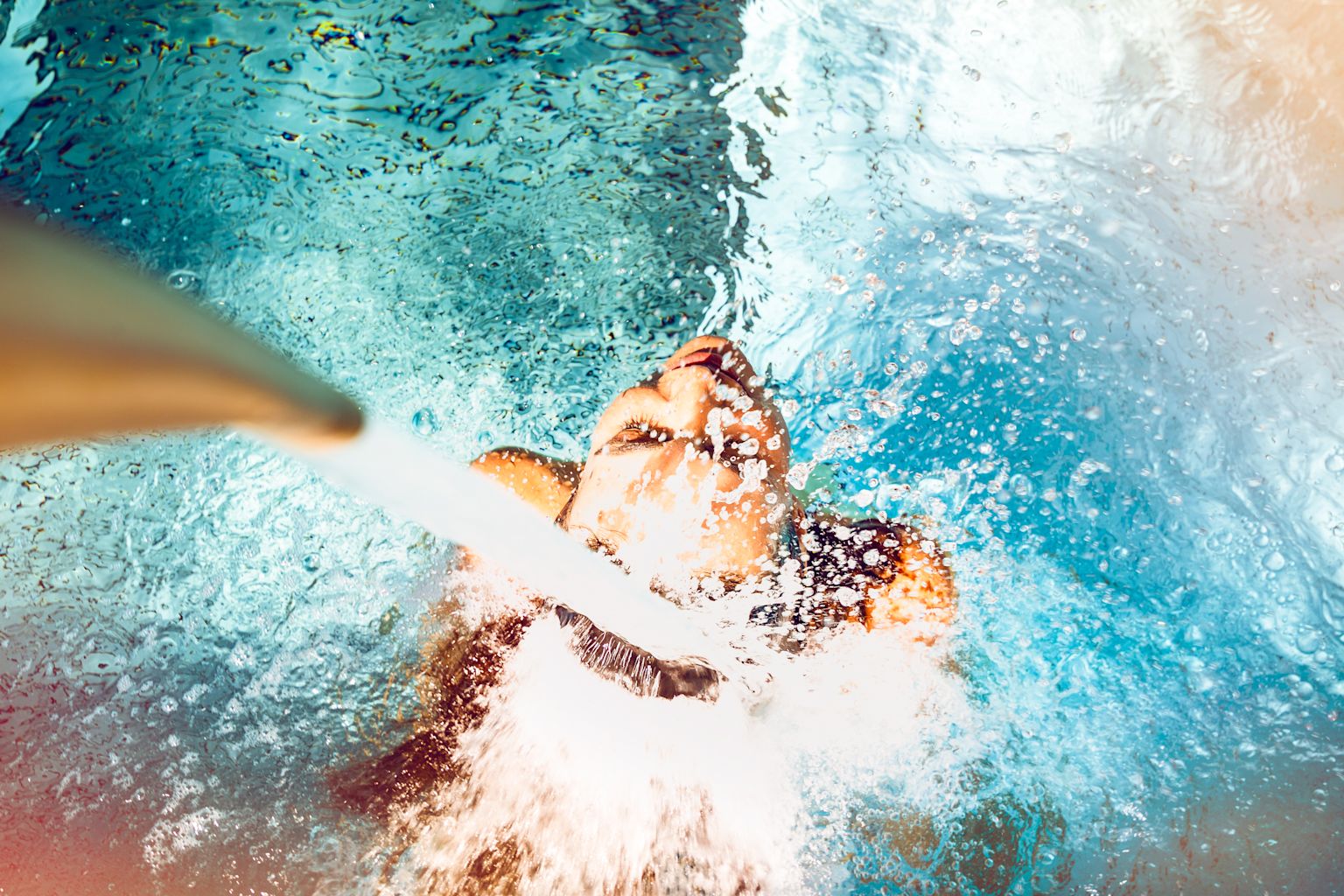 A girl under a jet from the Saillon baths. Valais, Switzerland.