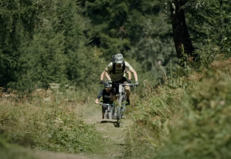 Two mountain bikers on the Valais Alpine Bike route between Brig and Blatten, Valais, Switzerland.