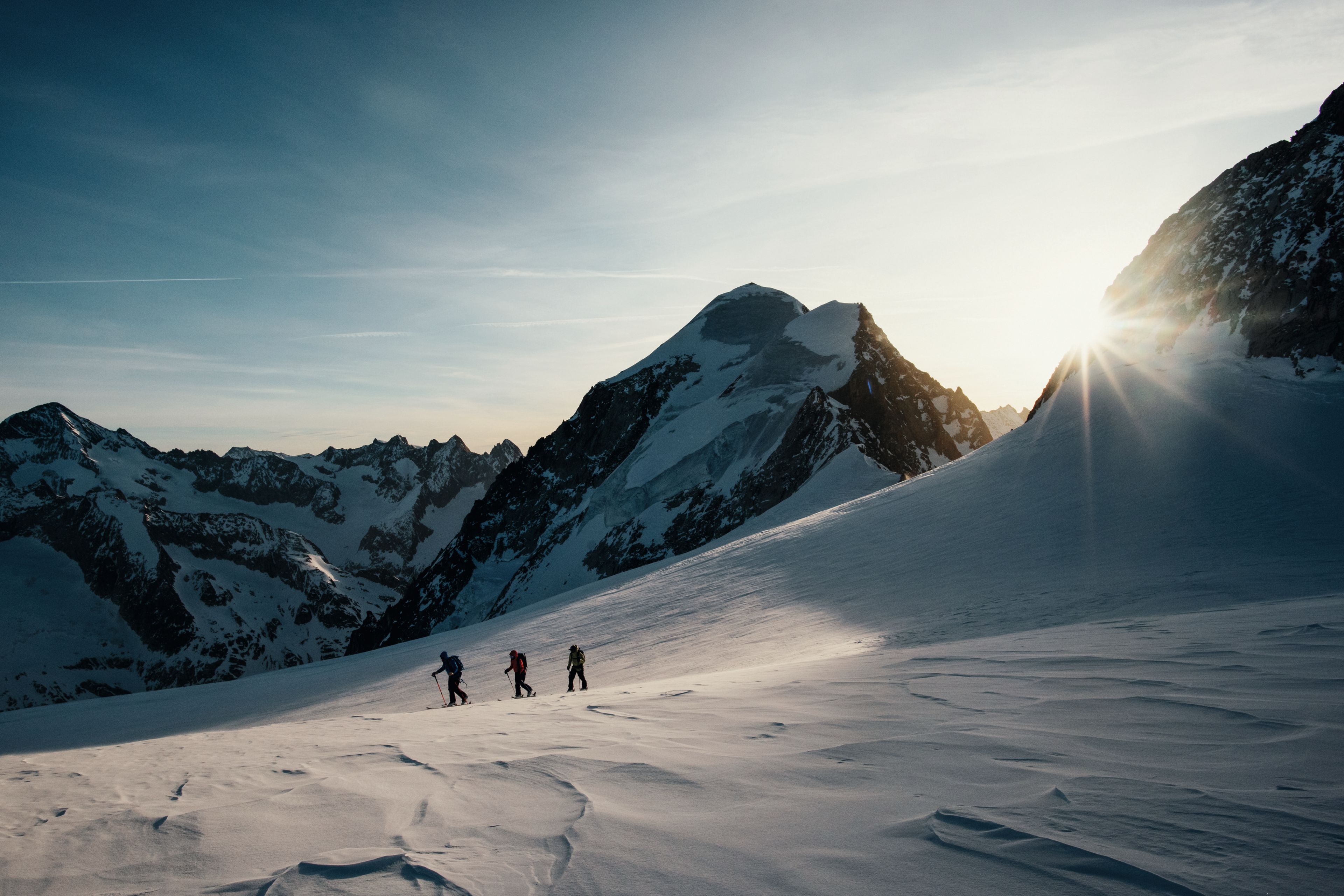 The sun rises on hikers in the Lötschental