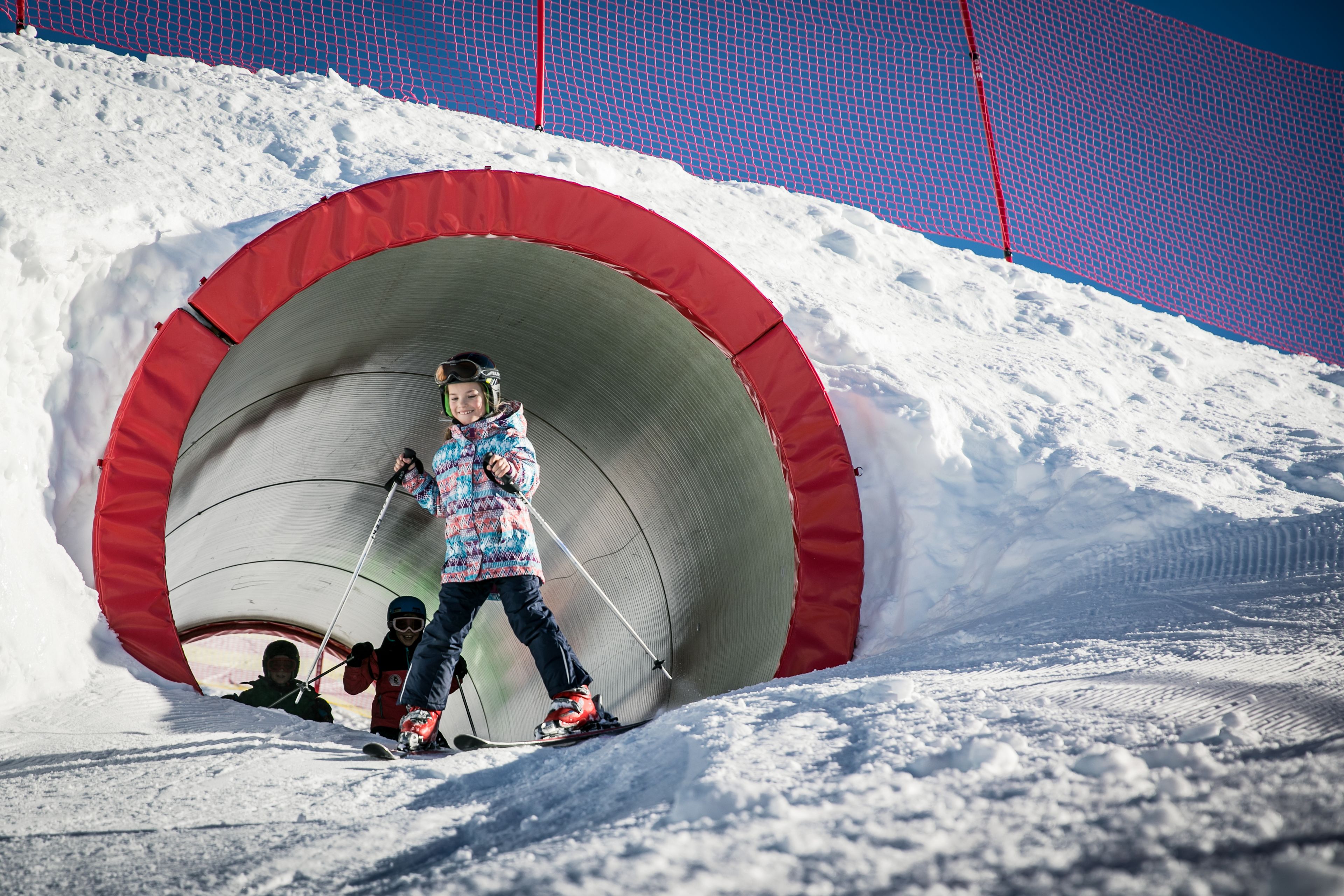 Girl skiing in red tunnel at Kinderland Kreuzboden