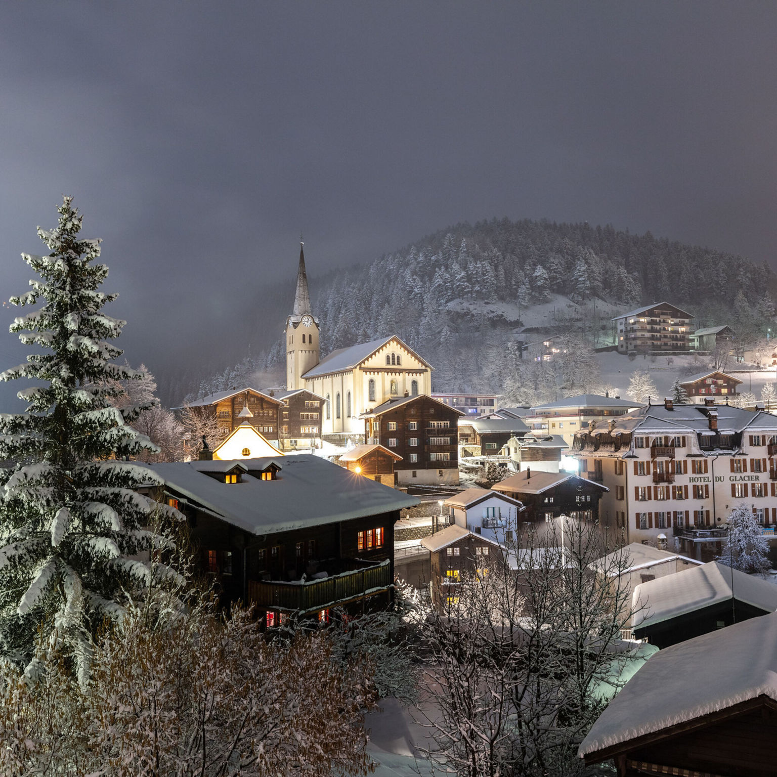 Snow-covered roofs over the village of Fiesch, Aletsch Arena, winter in Valais, Switzerland