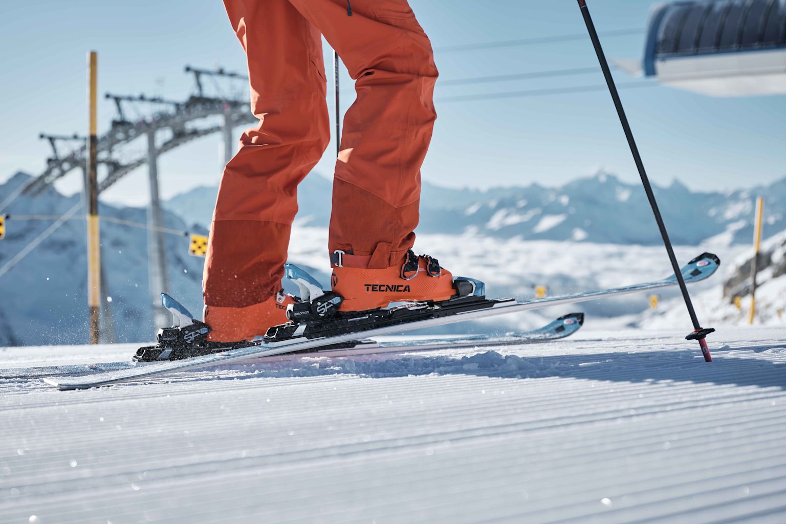 Skiing, skier at the top of a ski lift ready to make a nice descent. Valais, Switzerland