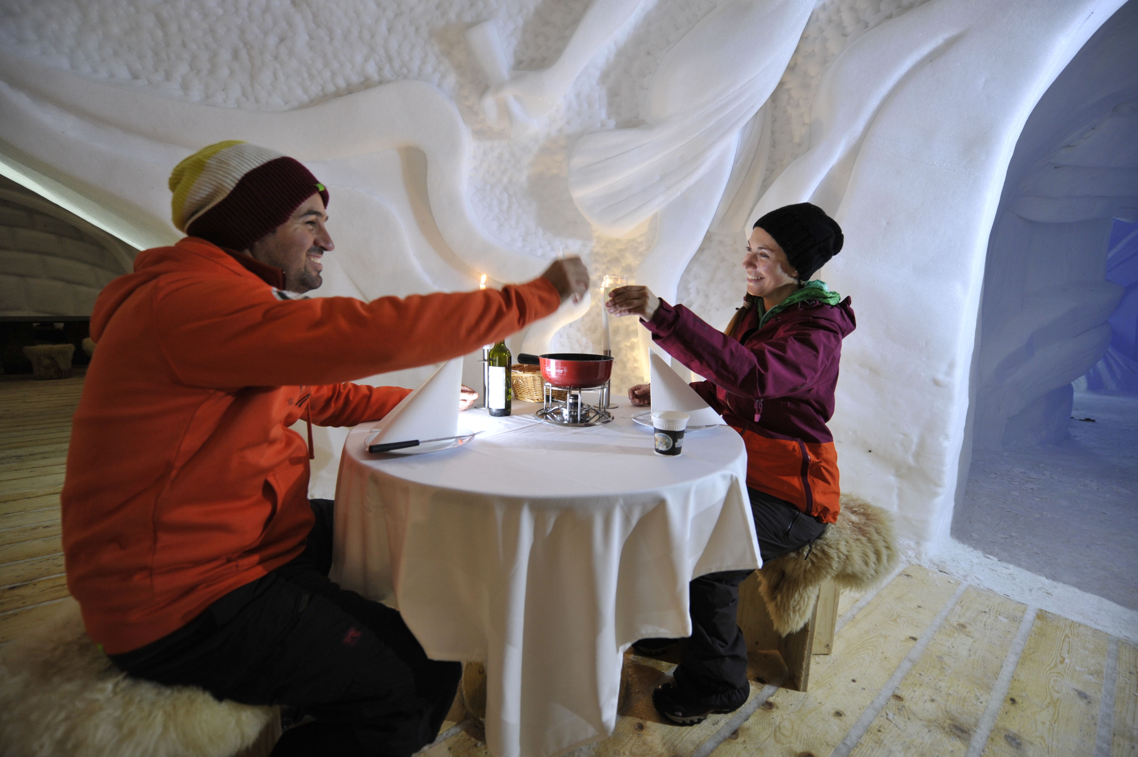 Tasting a good fondue in an igloo, Valais Wallis Switzerland