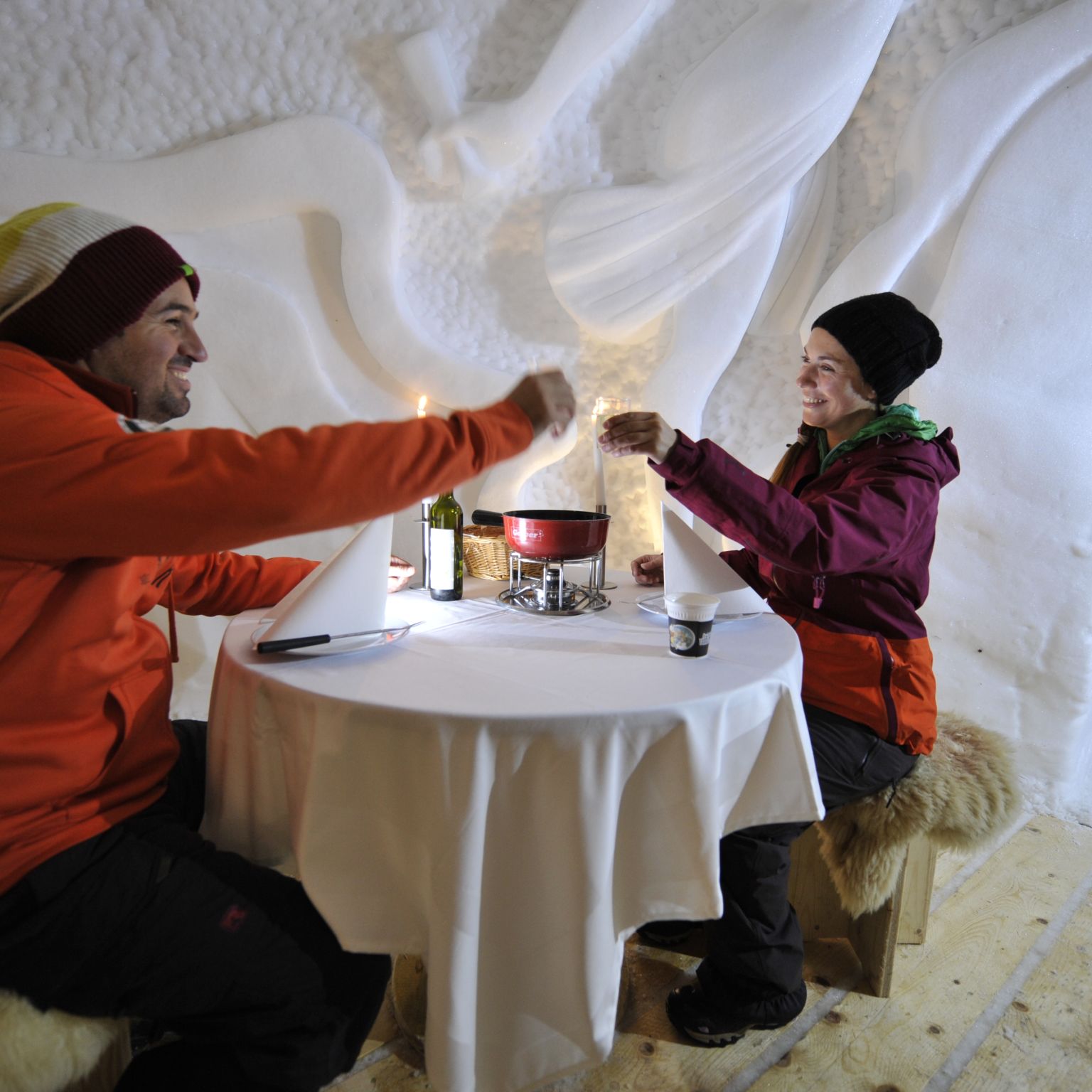Tasting a good fondue in an igloo, Valais Wallis Switzerland
