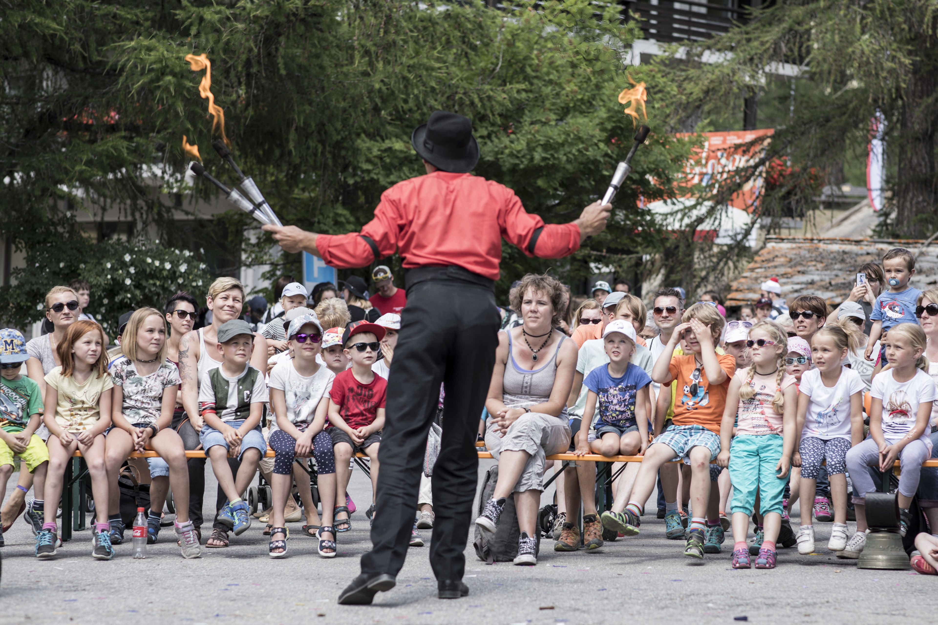 A man juggling in front of an audience at Kids Days, Valais, Switzerland