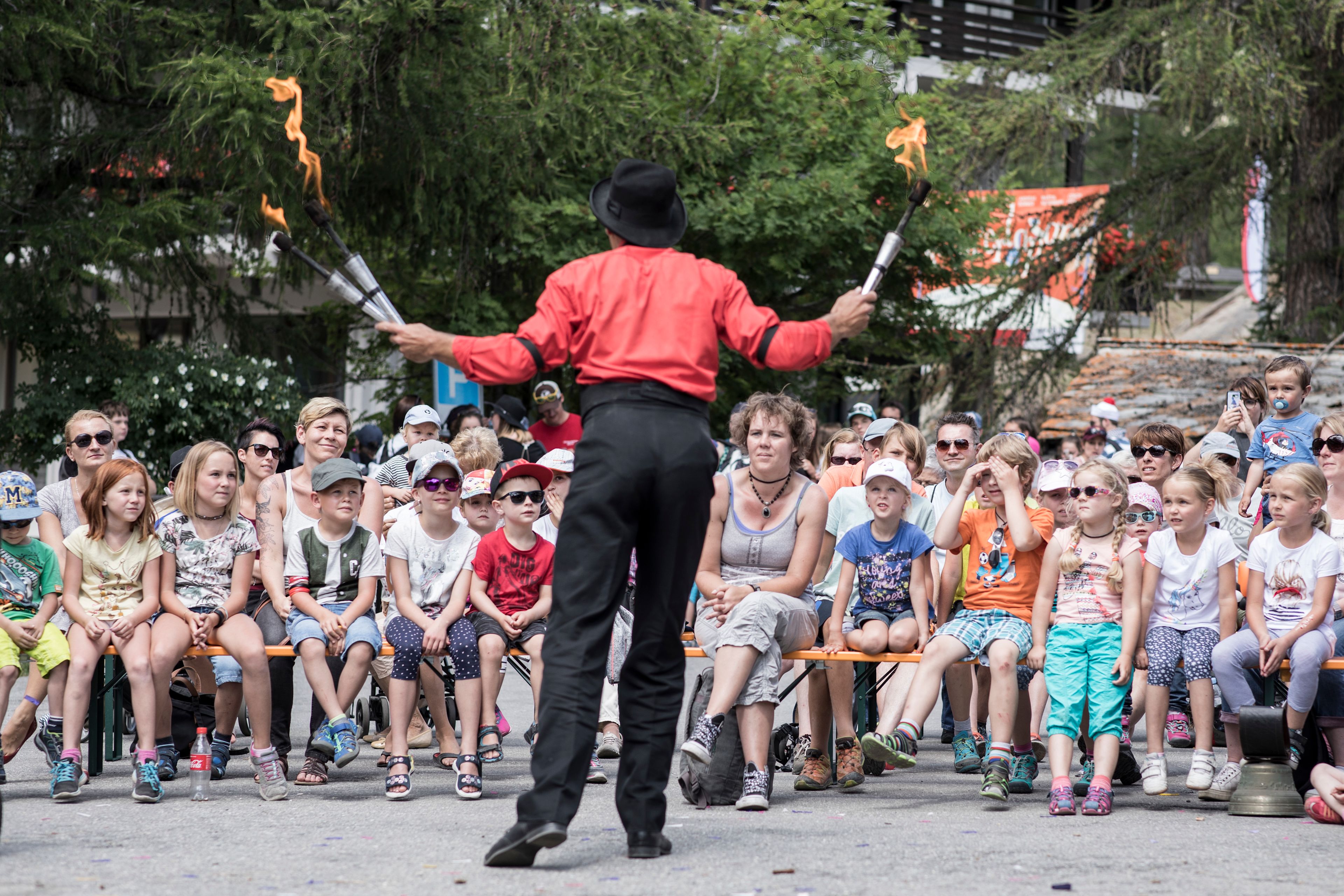 A man juggling in front of an audience at Kids Days, Valais, Switzerland
