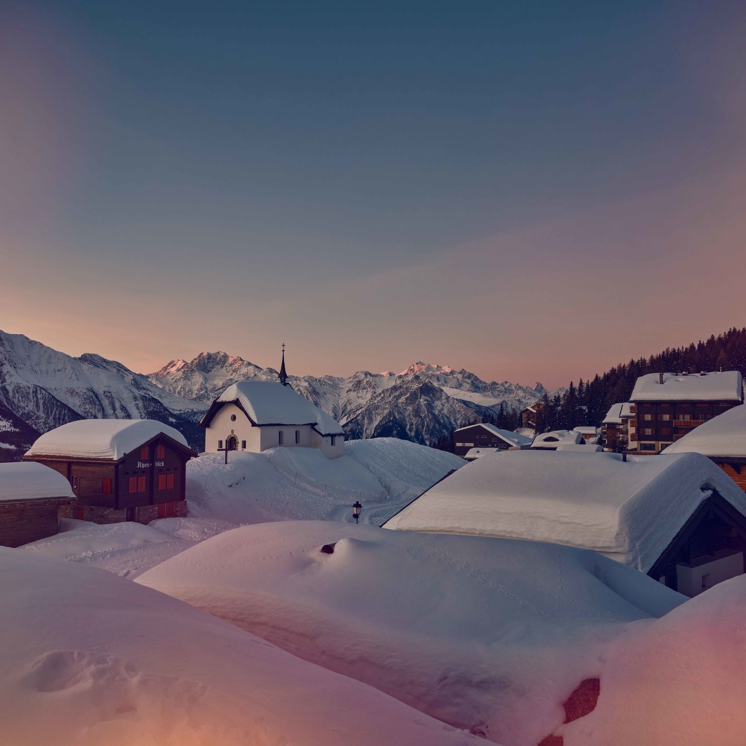 Snow covered roofs in Aletsch Arena, winter in Valais, Switzerland
