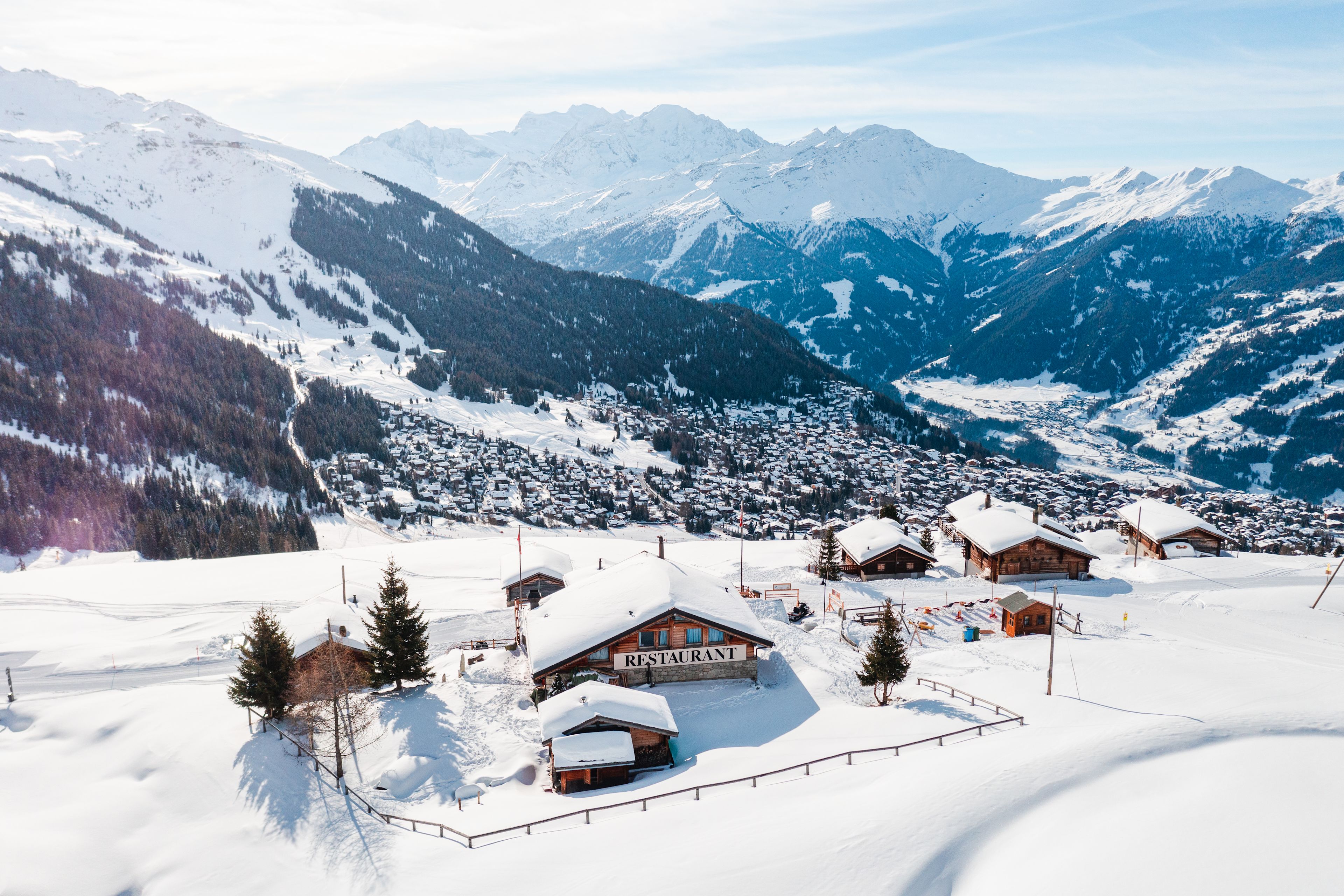 The La Marmotte restaurant in Verbier, Valais, surrounded by chalets and snowy mountains