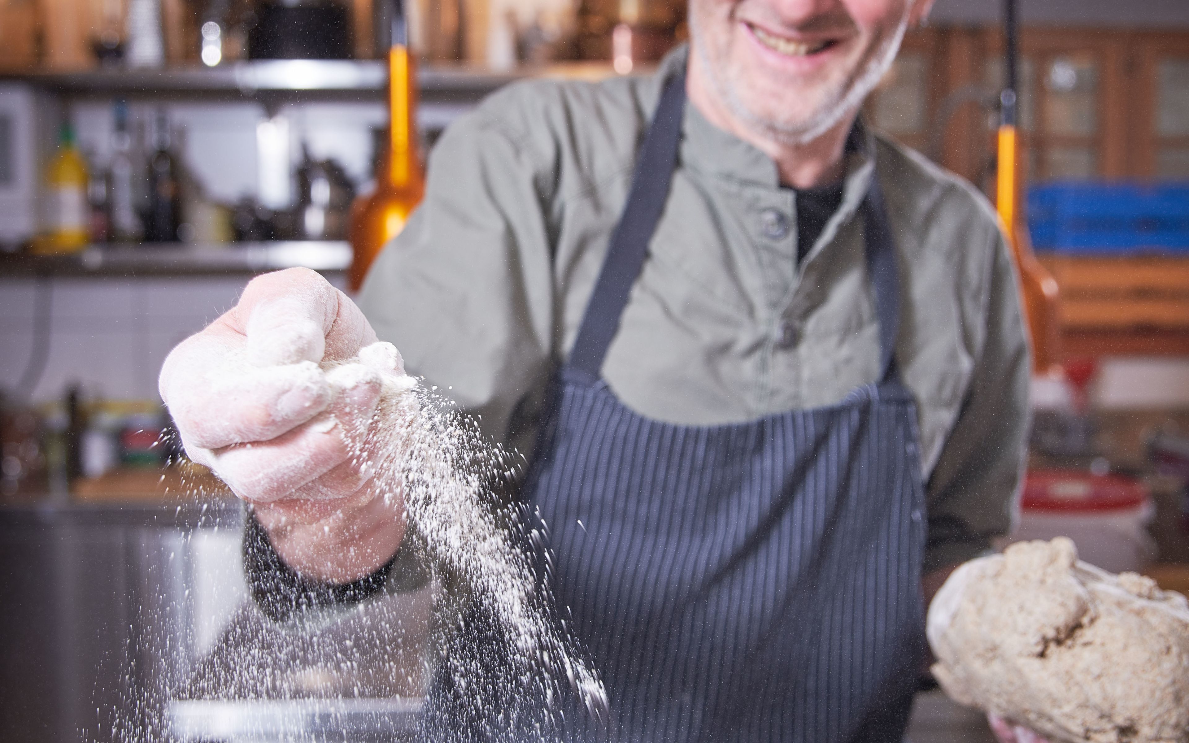 Klaus Leuenberger at work with dough and flour, Valais, Switzerland