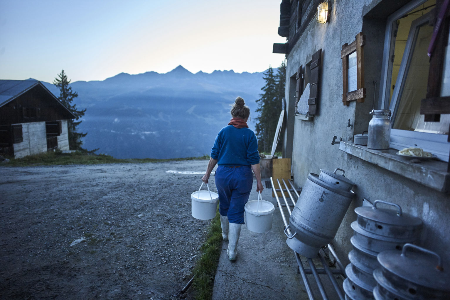 Farmer at the alpine cheese dairy, Valais, Switzerland