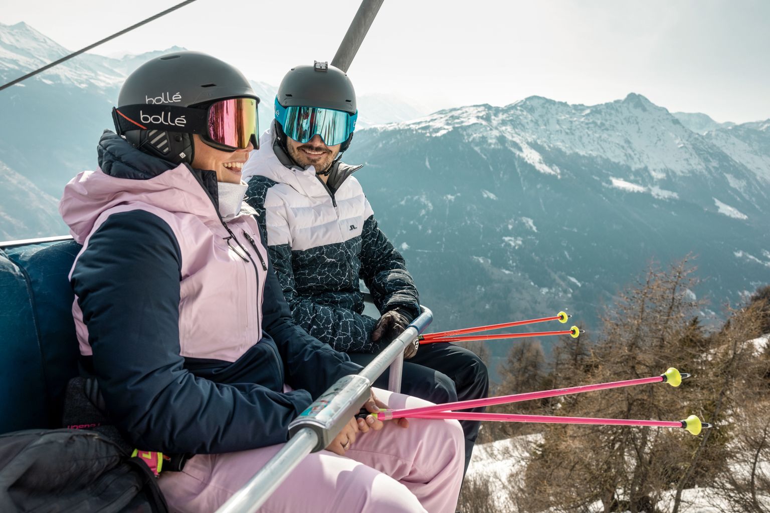 Loic and Mélanie Meillard talking on a chairlift in Thyon, Valais.