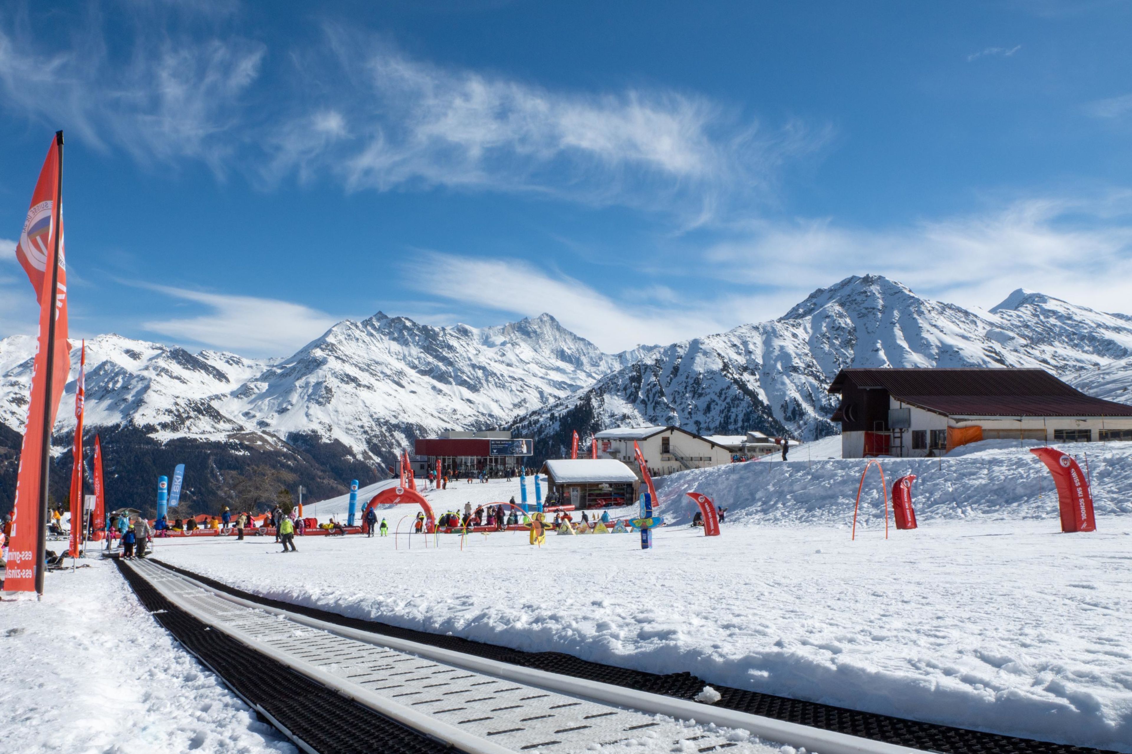 Kinder lernen das Skifahren im Minigliss-Gelände in Grimentz vor alpiner Kulisse