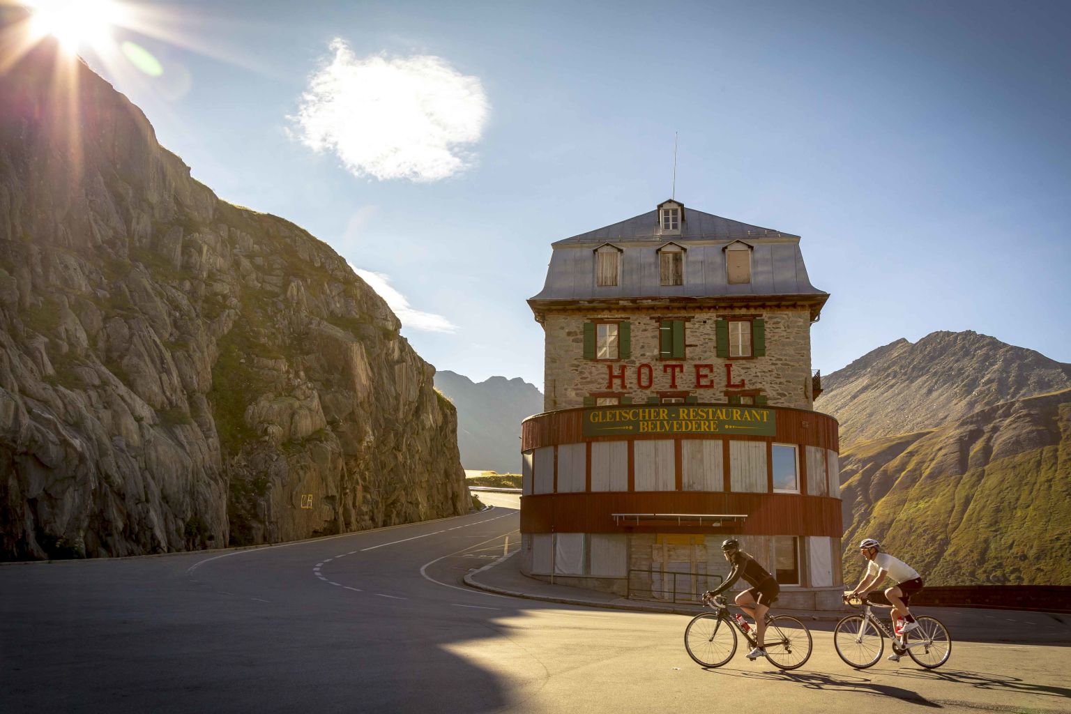 Two cyclists on the Furka climb ride in the Hotel Belvedere. Valais, Switzerland