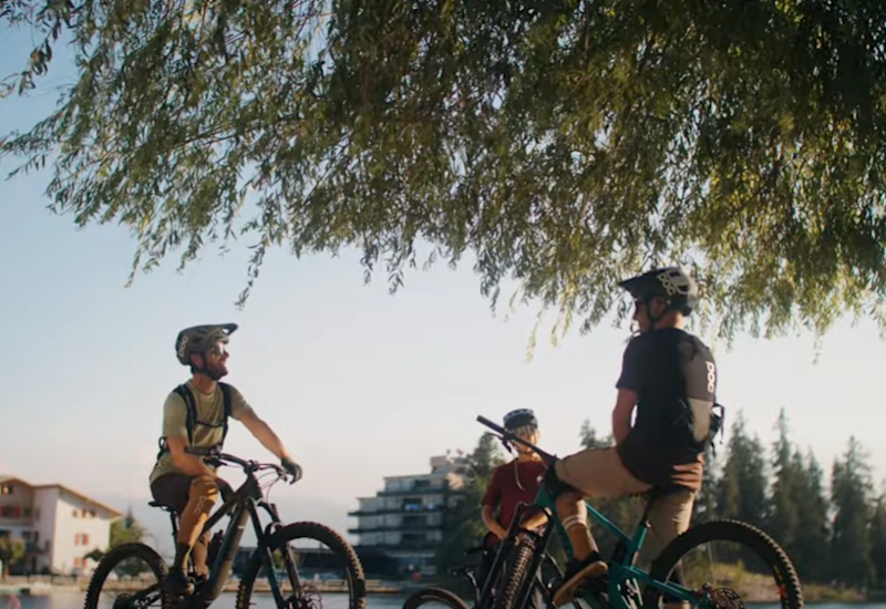 Three mountain bikers on the Valais Alpine Bike route between Crans-Montana and Leukerbad, Valais, Switzerland.