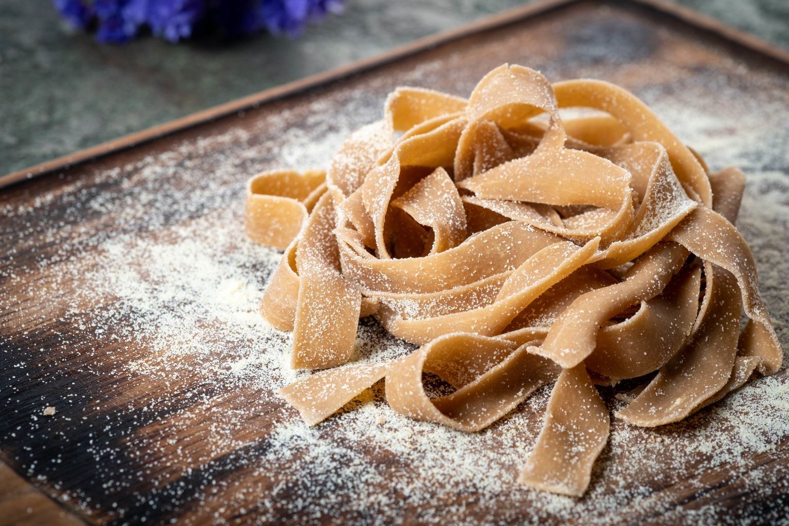 Tagliatelle on a board sprinkled with chestnut flour, Valais, Switzerland