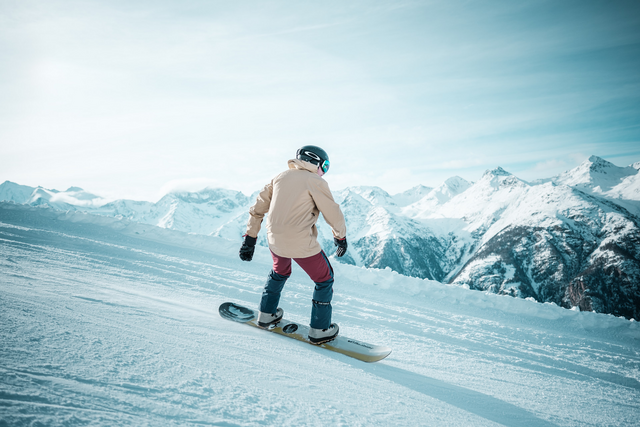 A snowboarder enjoying Grächen's perfectly groomed slopes.