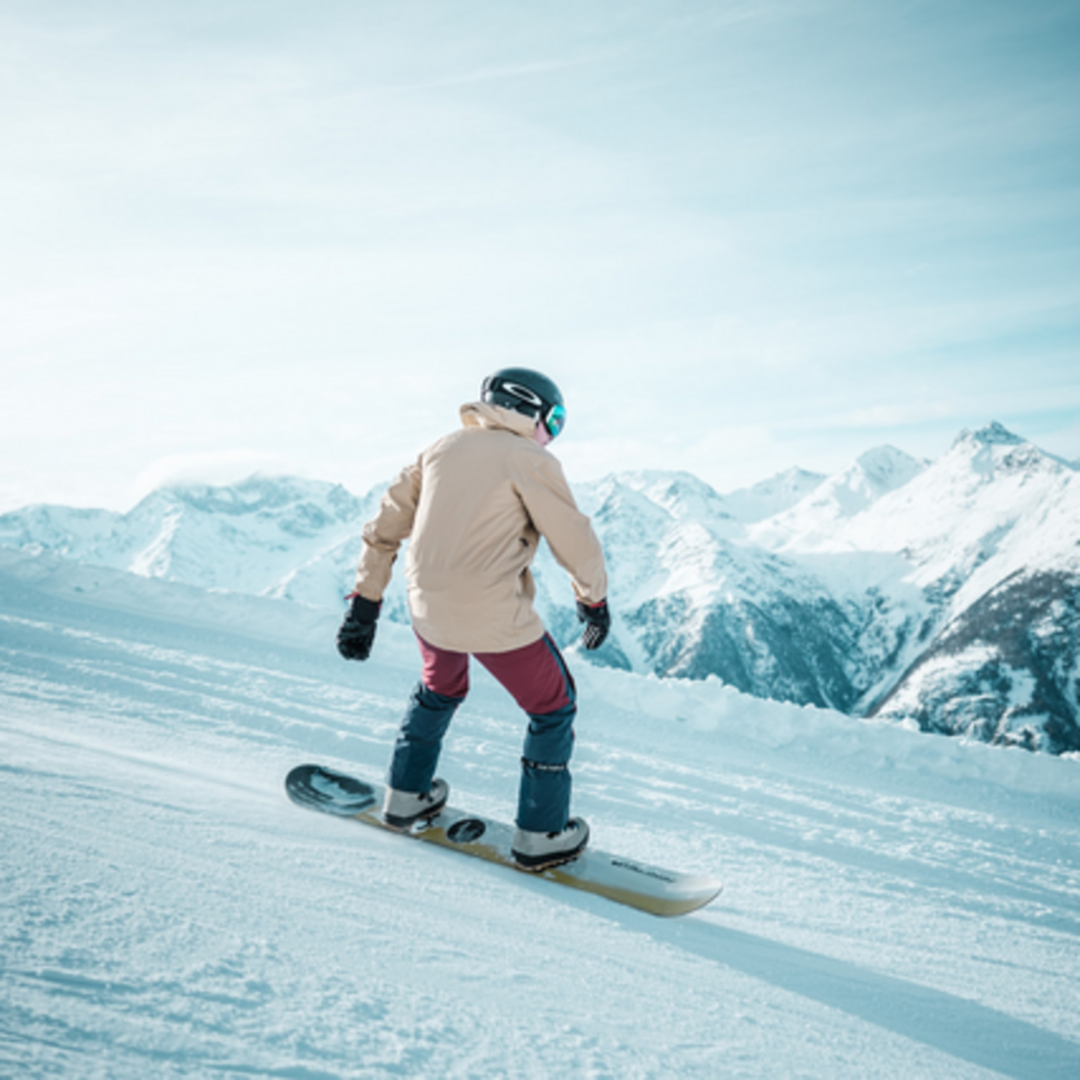 A snowboarder enjoying Grächen's perfectly groomed slopes.
