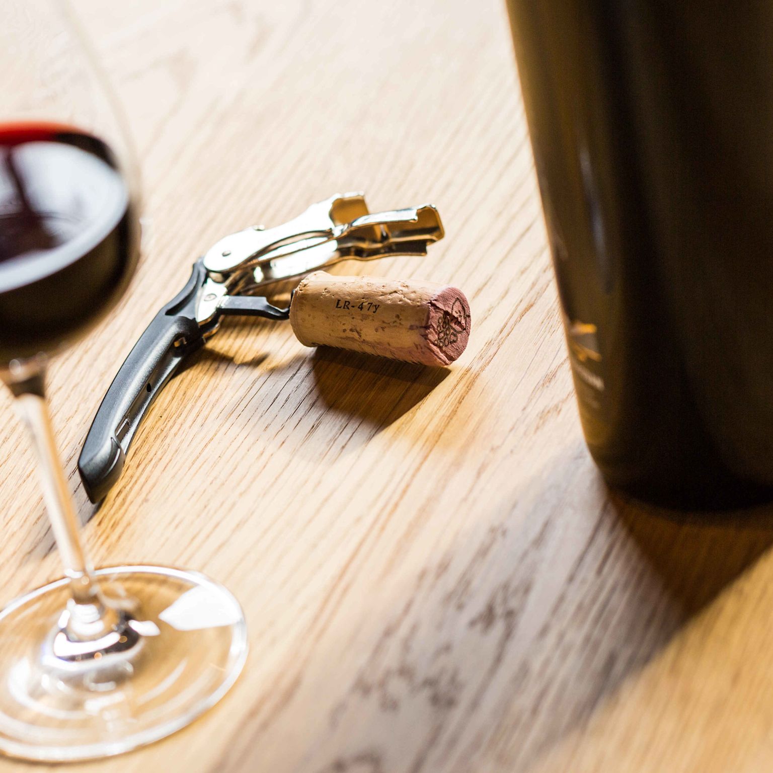 A bottle of Valaisan wine with its corkscrew and a wine glass, Valais Switzerland