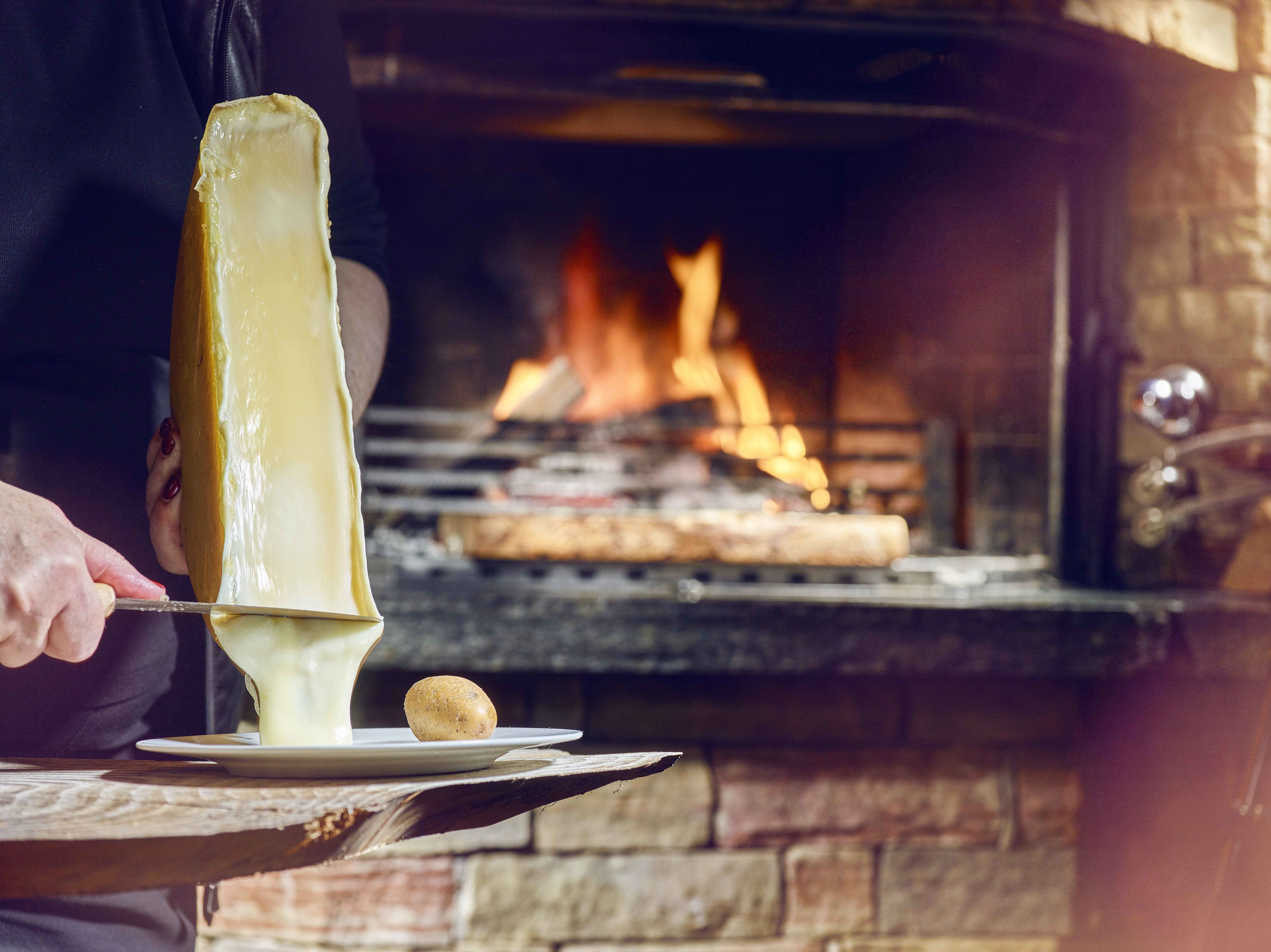 Raclette with wood fire, Valais speciality Valais Wallis Schweiz Suisse