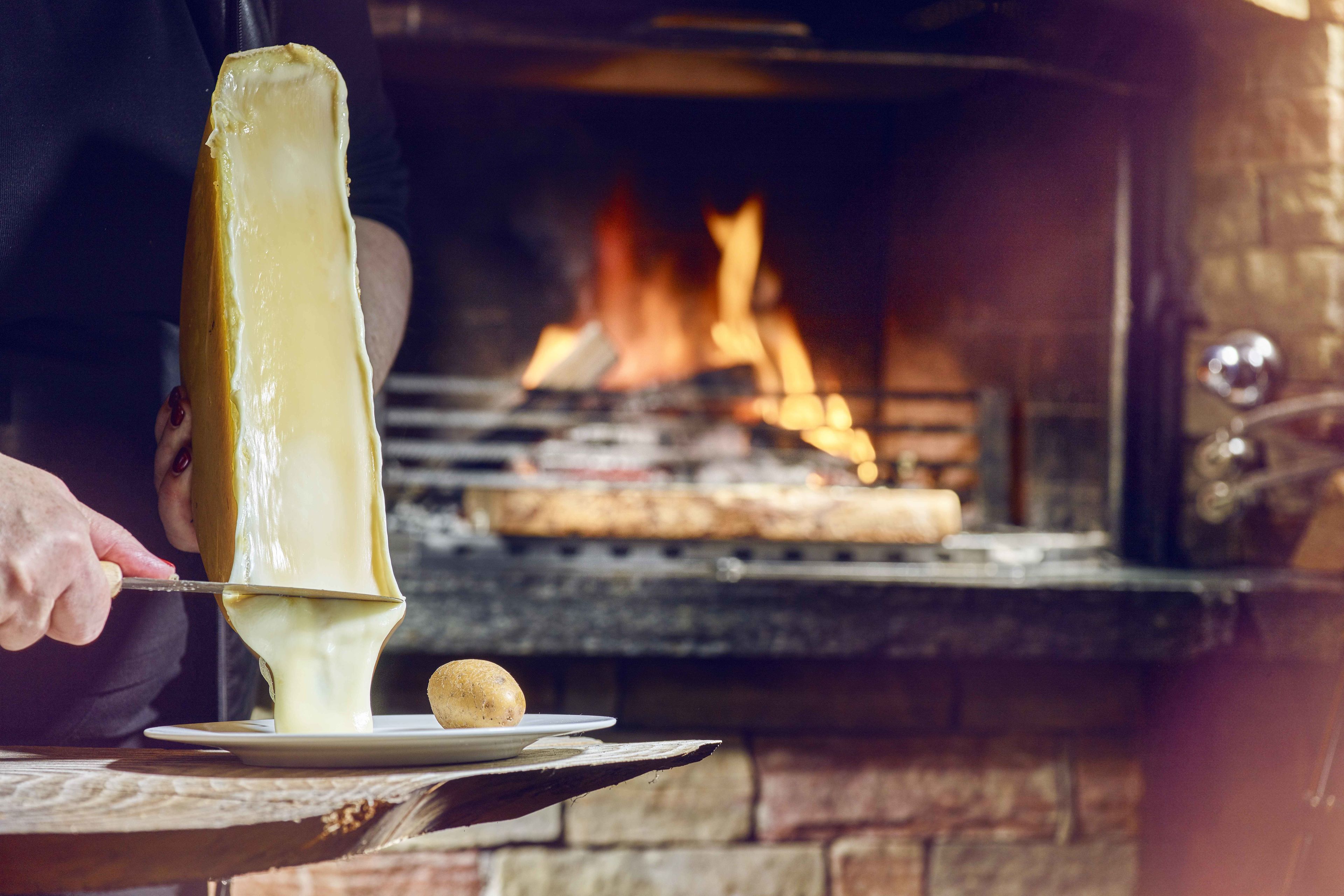 Raclette with wood fire, Valais speciality Valais Wallis Schweiz Suisse