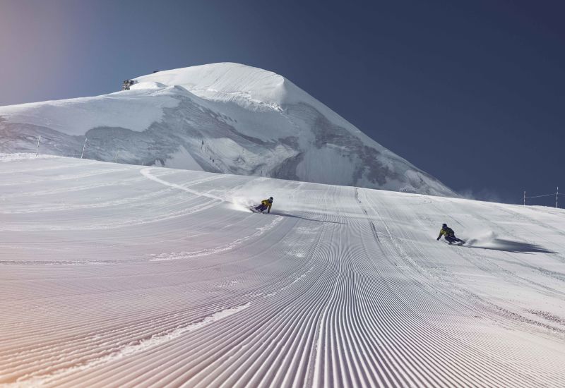 Skiing in Saas-Fee with view of Allalinhorn, winter in Valais, Switzerland