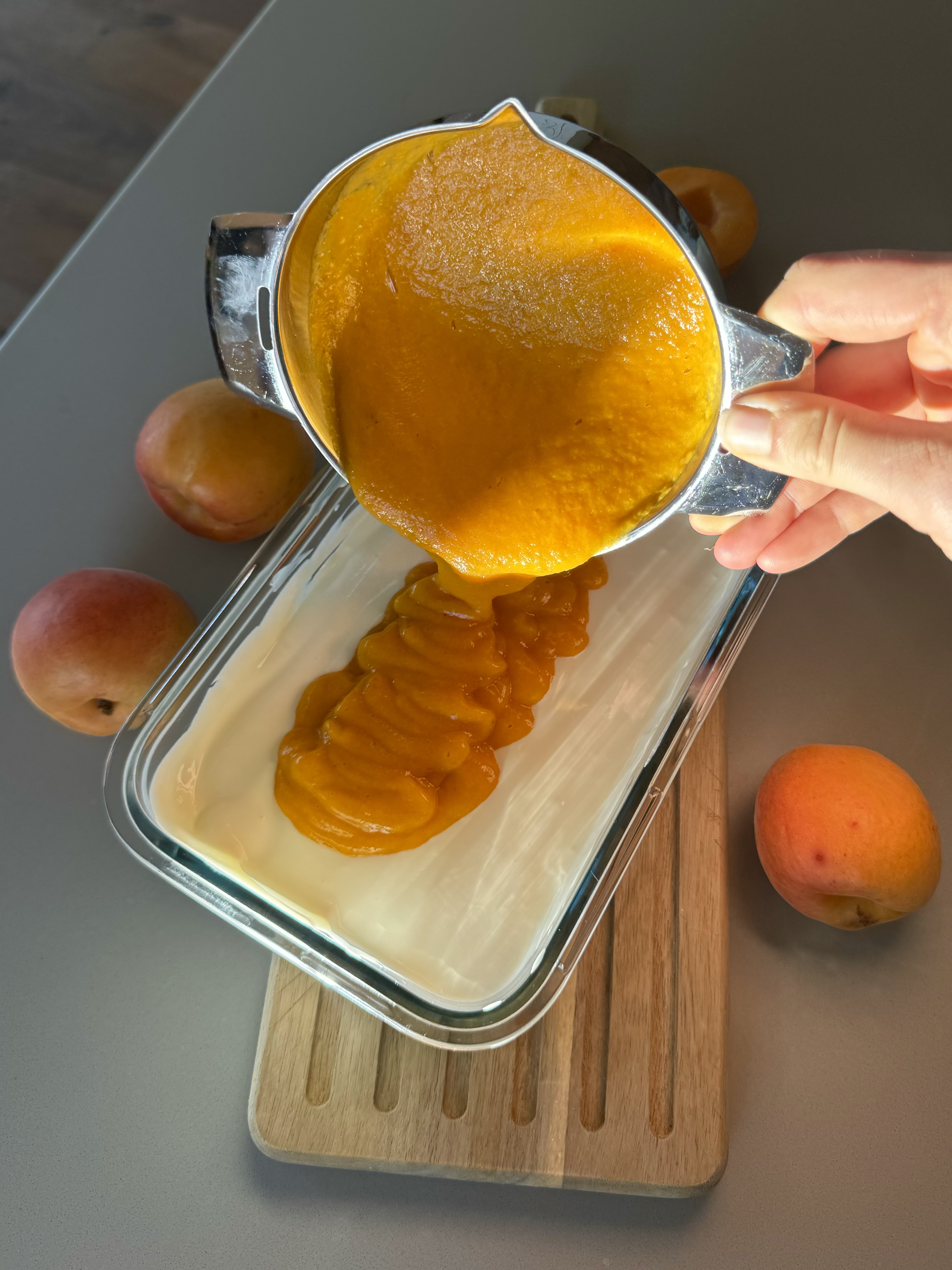 Valais apricot coulis being poured into the ice cream mixture