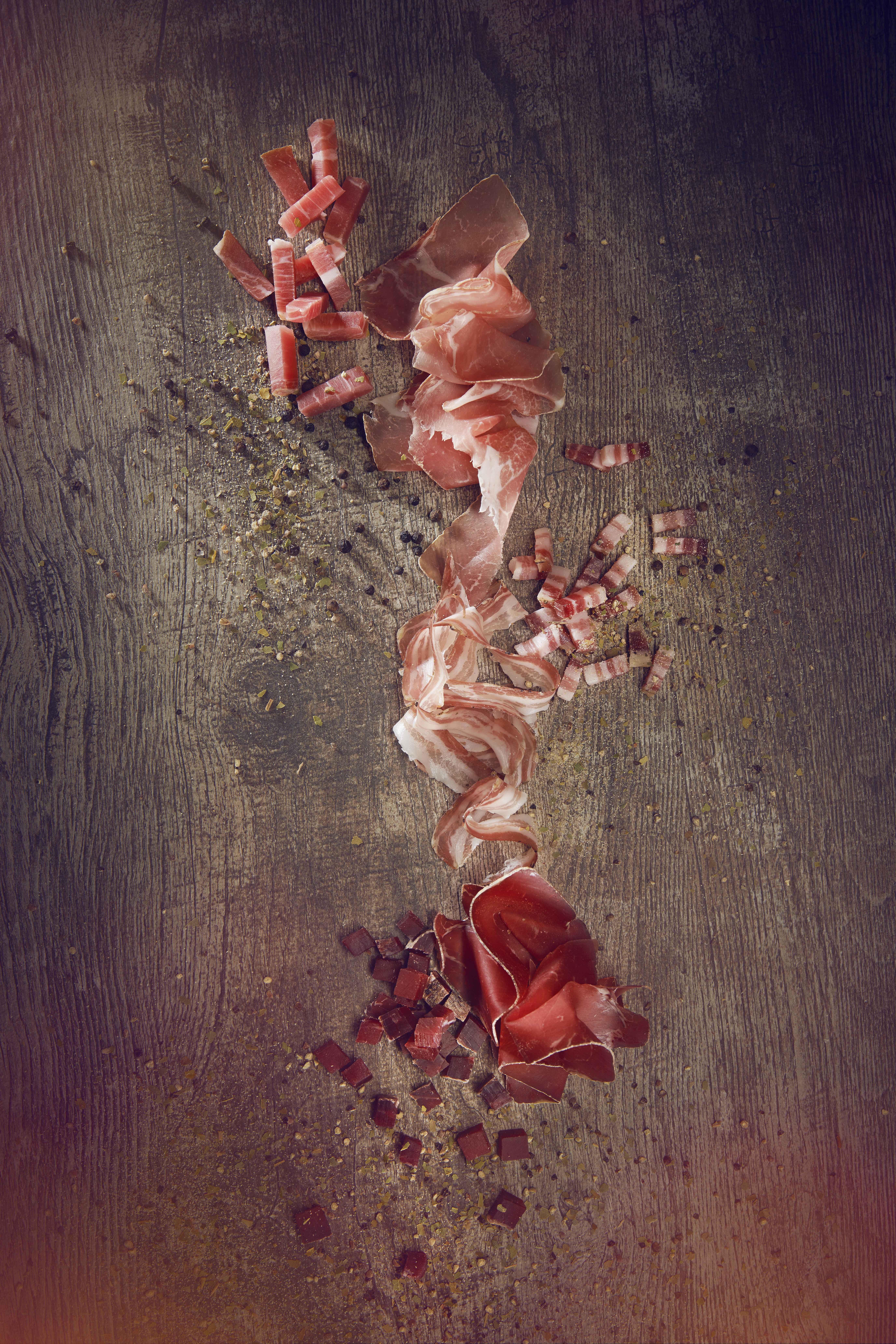 Valais dried meats (dried meat, dry bacon and raw ham) on a wooden table, Valais Wallis Schweiz Suisse