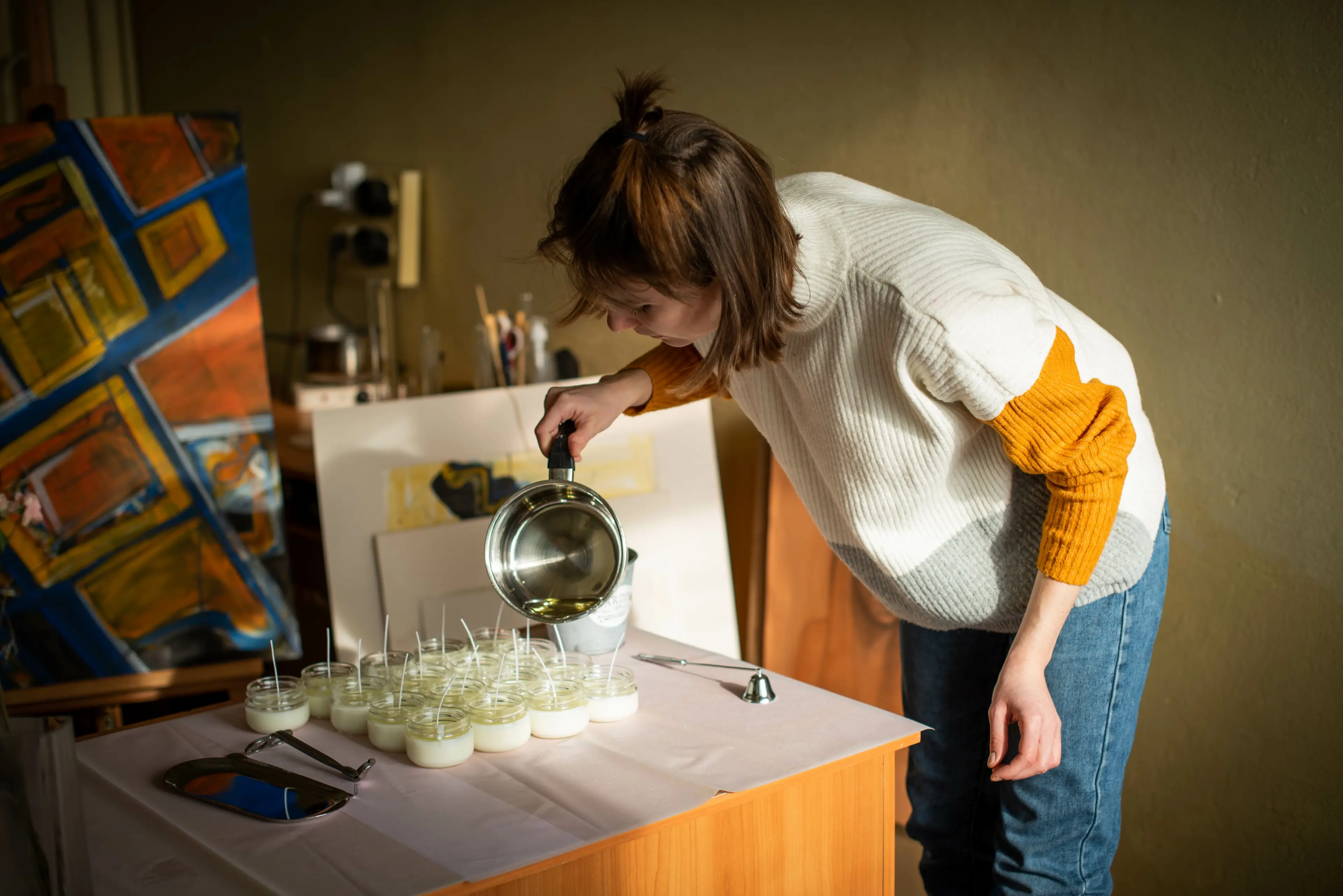 A woman making artisanal candles for her online business