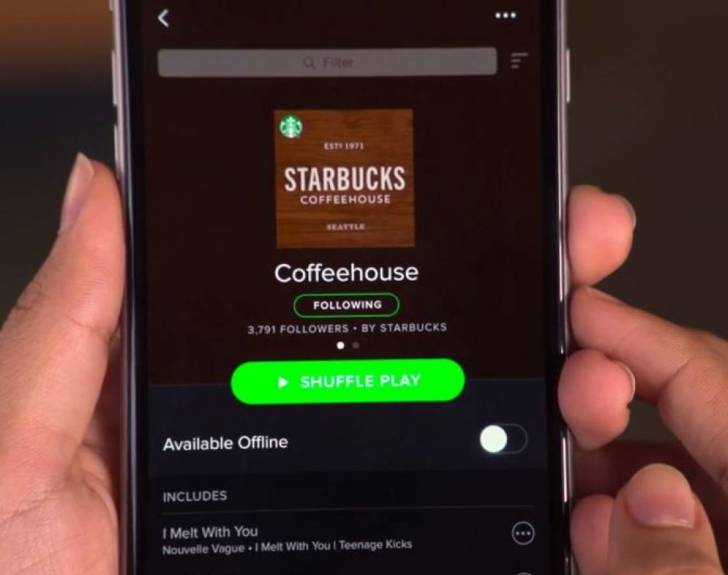 An image of a mobile phone with the Spotify app open playing the Starbucks playlist