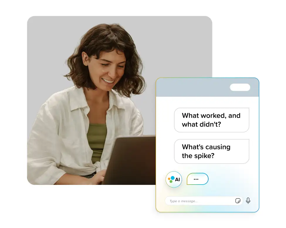 A woman smiling while using a laptop, with an overlay of an AI chat interface showing messages that read “What worked, and what didn’t?” and “What’s causing the spike?” — representing interaction with an AI assistant or copilot tool.