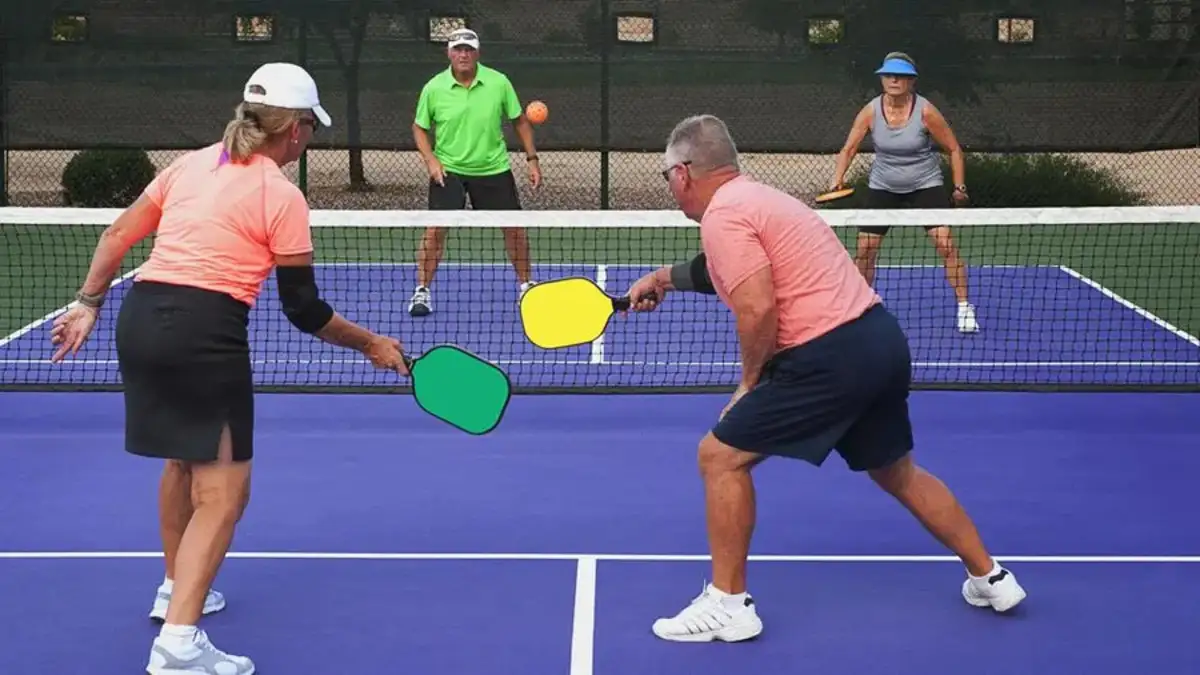 A group of senior citizens enjoying a game of pickleball on a sunny day. 