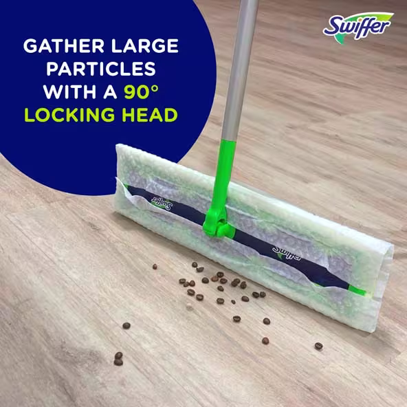 Swiffer sweeper with a 90° locking head, gathering coffee beans on a wooden floor surface for efficient cleaning