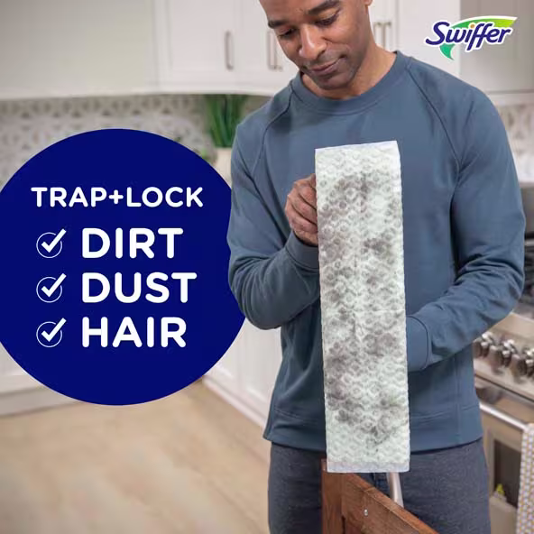 Person using a Swiffer cloth to trap and lock dirt, dust, and hair in a kitchen setting