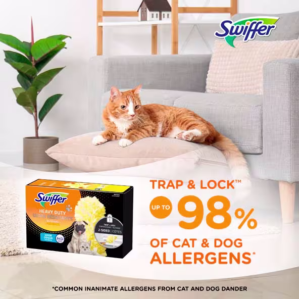 A relaxed orange cat sits on a cushion beside a Swiffer Pet product, promoting allergen reduction for pet owners