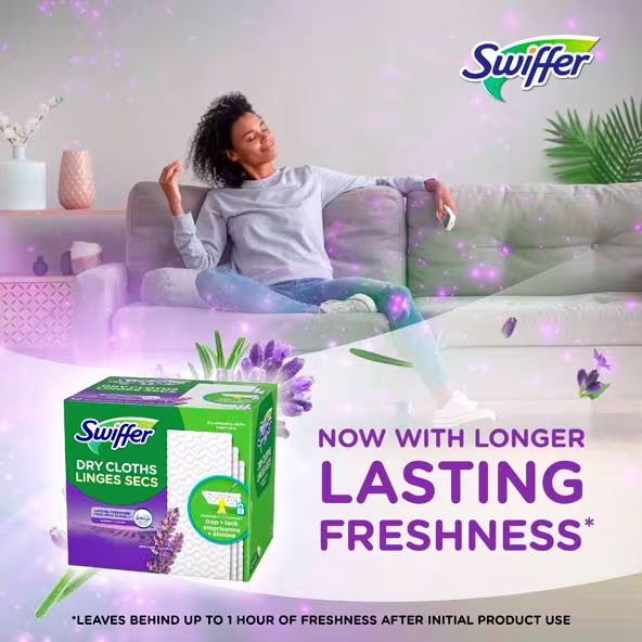 A relaxed woman enjoys the freshness of Swiffer Dry Cloths while sitting on a couch, showcasing product benefits