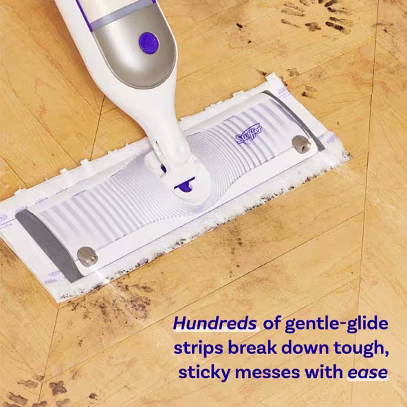 Swiffer mop on wooden floor, designed for easy cleaning of tough, sticky messes with gentle-glide strips