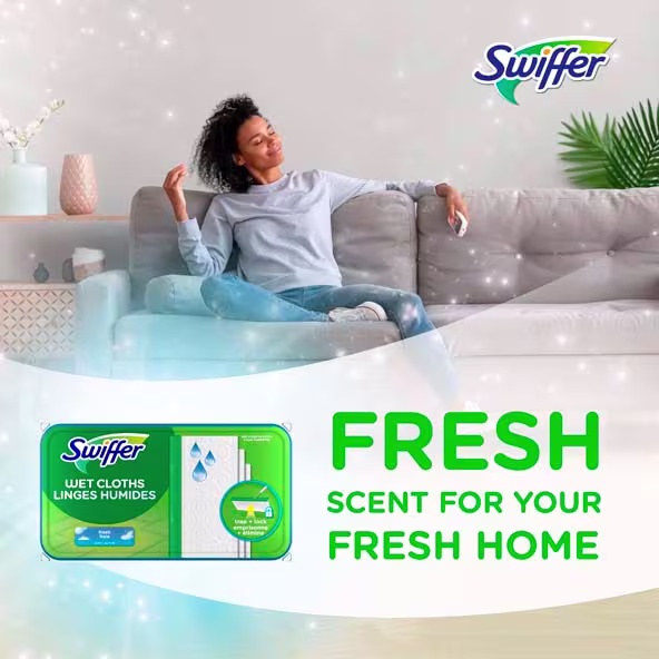 A man relaxes on a couch with Swiffer Wet Cloths, promoting long-lasting freshness