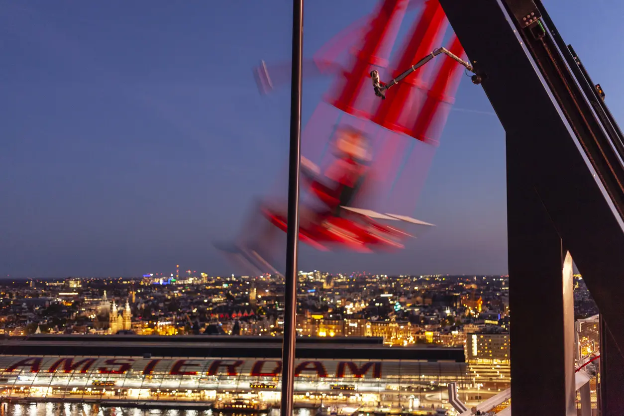 Blurred shot of person on swing high above viewpoint