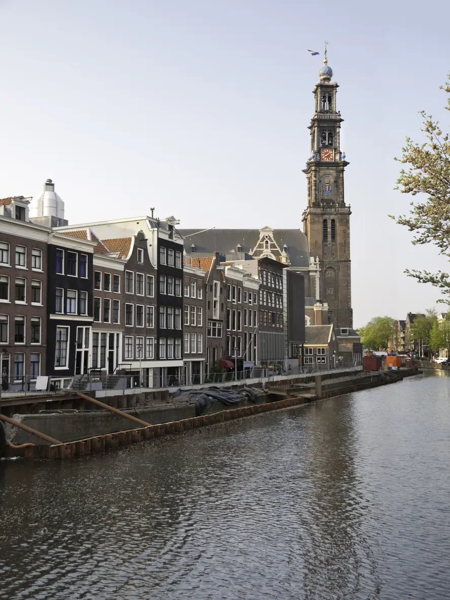 Canal in front of traditional houses and church