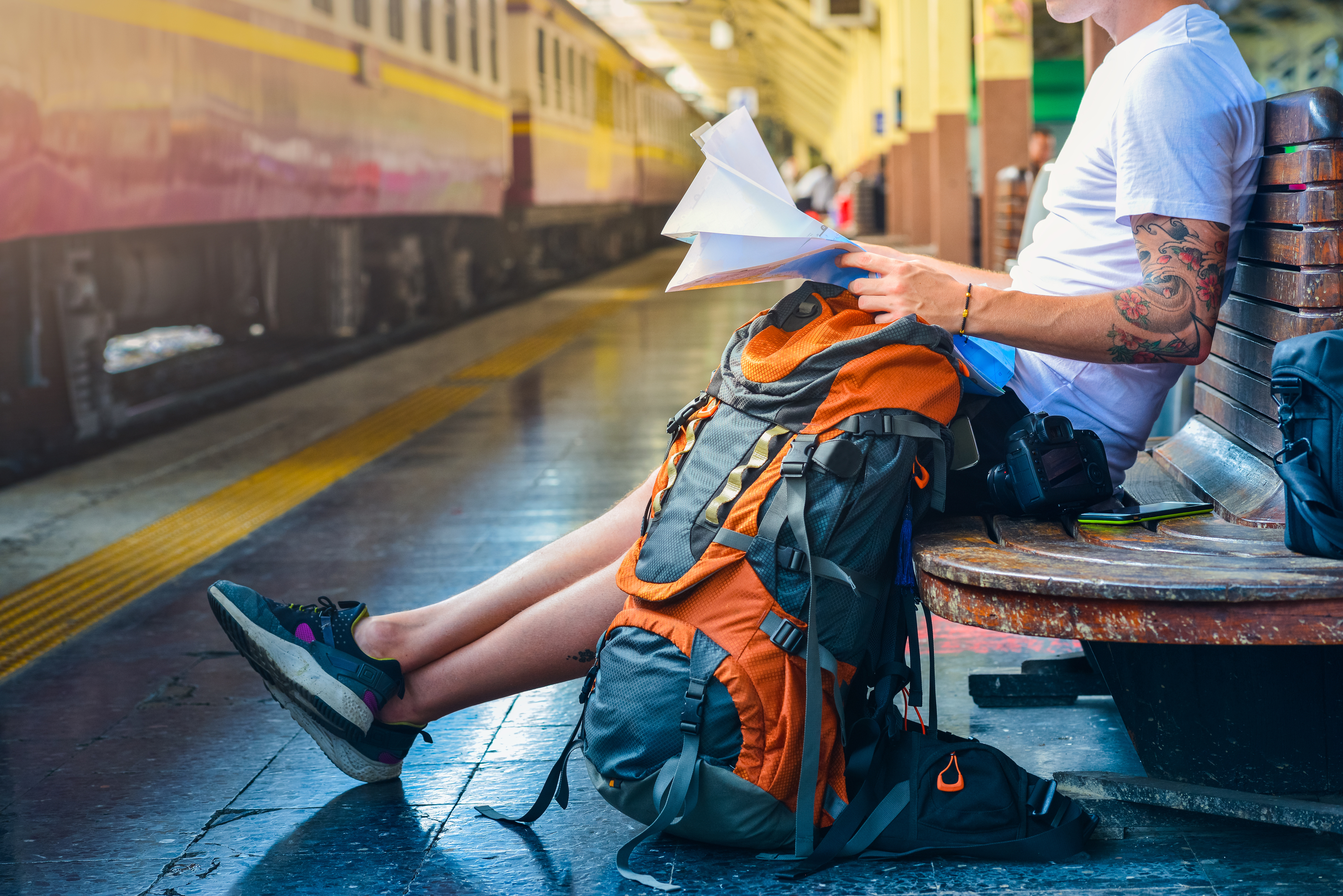 Waiting at a train station with a travel backpack