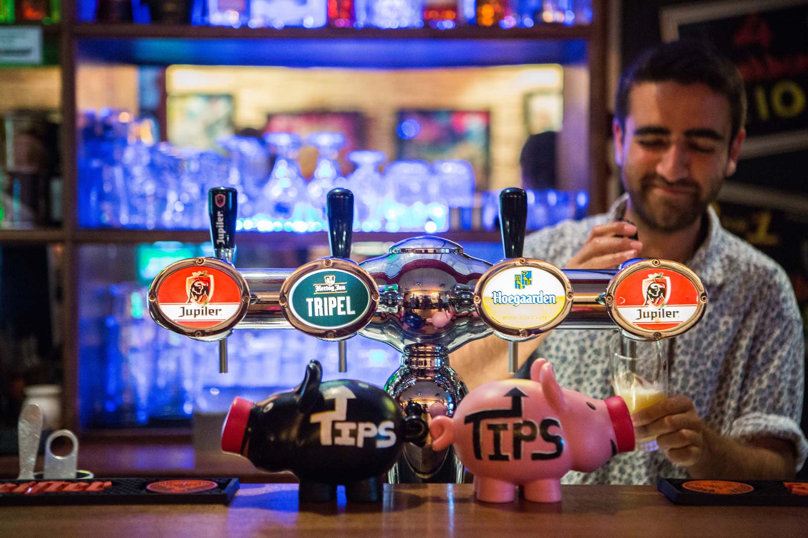 A bartender serving a beer at the Flying Pig Uptown.