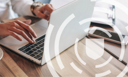 person typing on laptop with transparent shield icon and line pattern