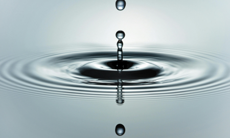 droplet of water landing in a pool of water