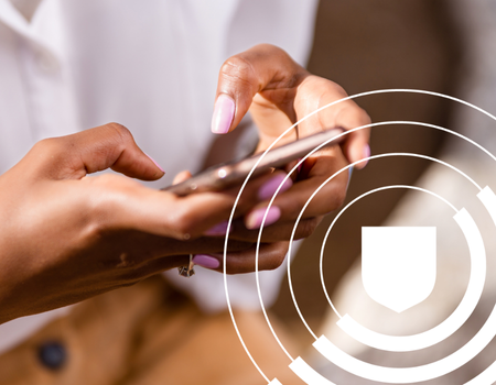 Person using a smartphone, with a shield icon overlay on the image.